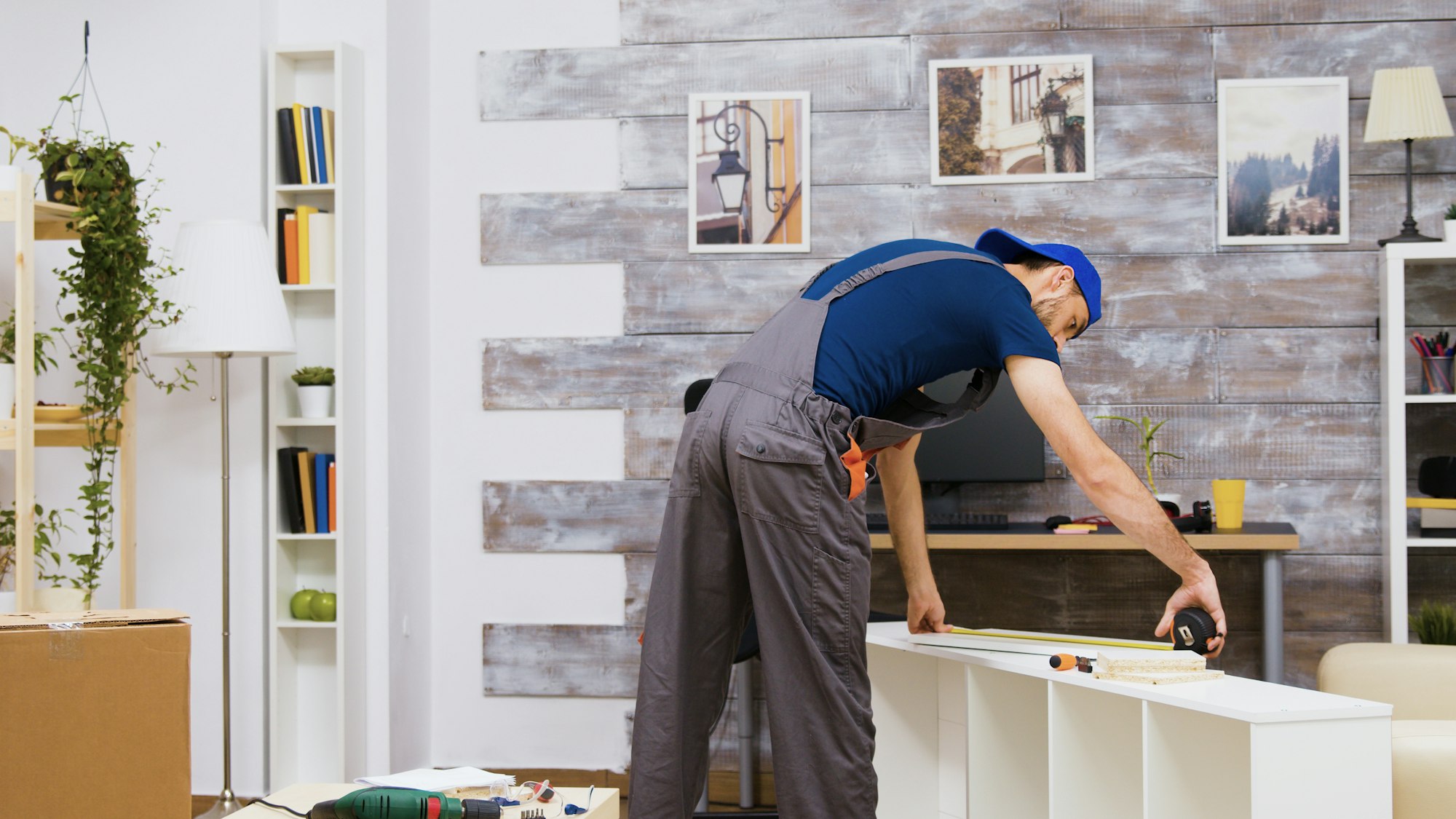 Furniture assembly worker standing reading instruction